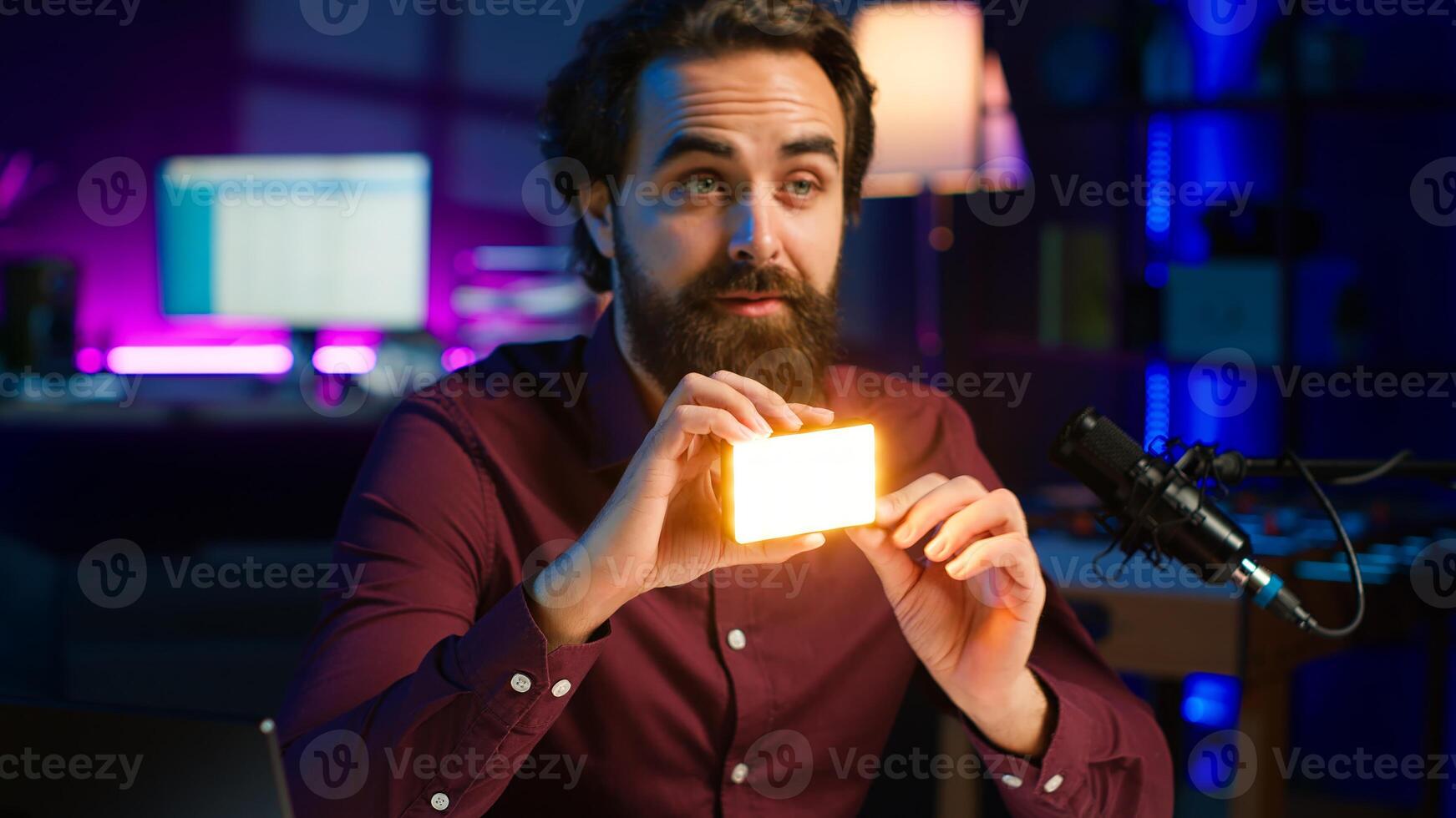Reviewer discussing with viewers about mini led lights during live broadcast on internet, close up. Influencer chatting with fans during stream, filming RGB lighting device in studio, camera A photo