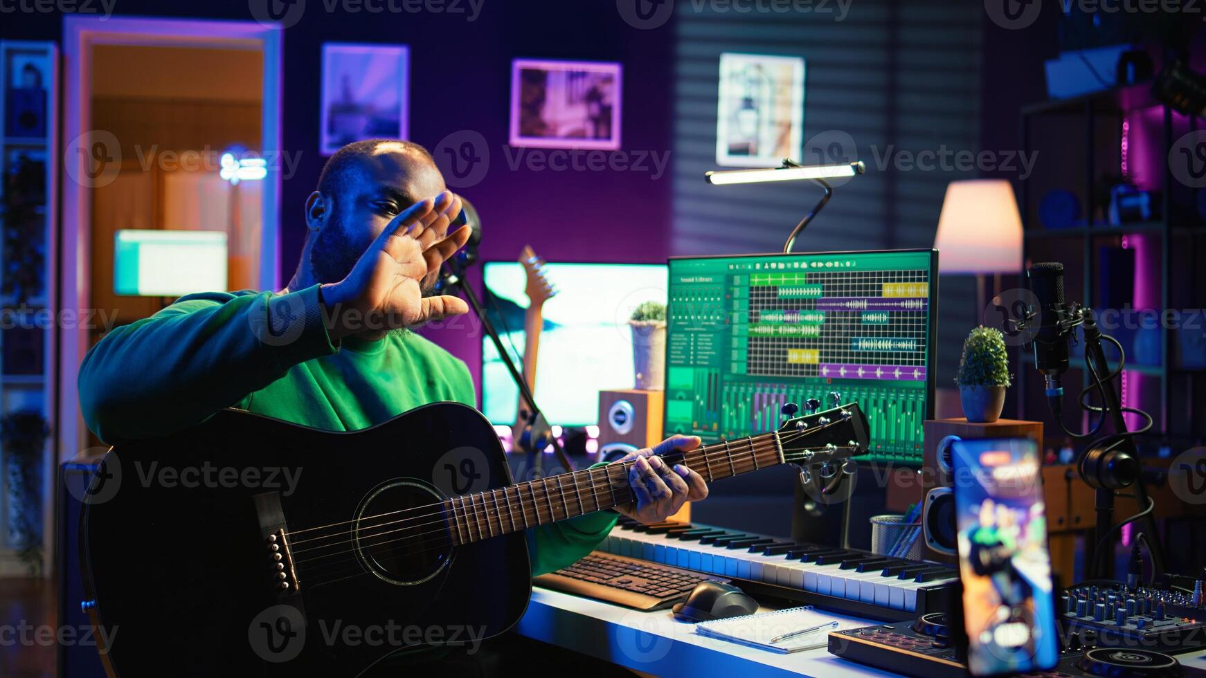 Talented performer teaching how to play acoustic guitar online for a tutorial, hosting internet master class to provide advice for beginners. Artist composer explaining accords on strings. Camera B. photo