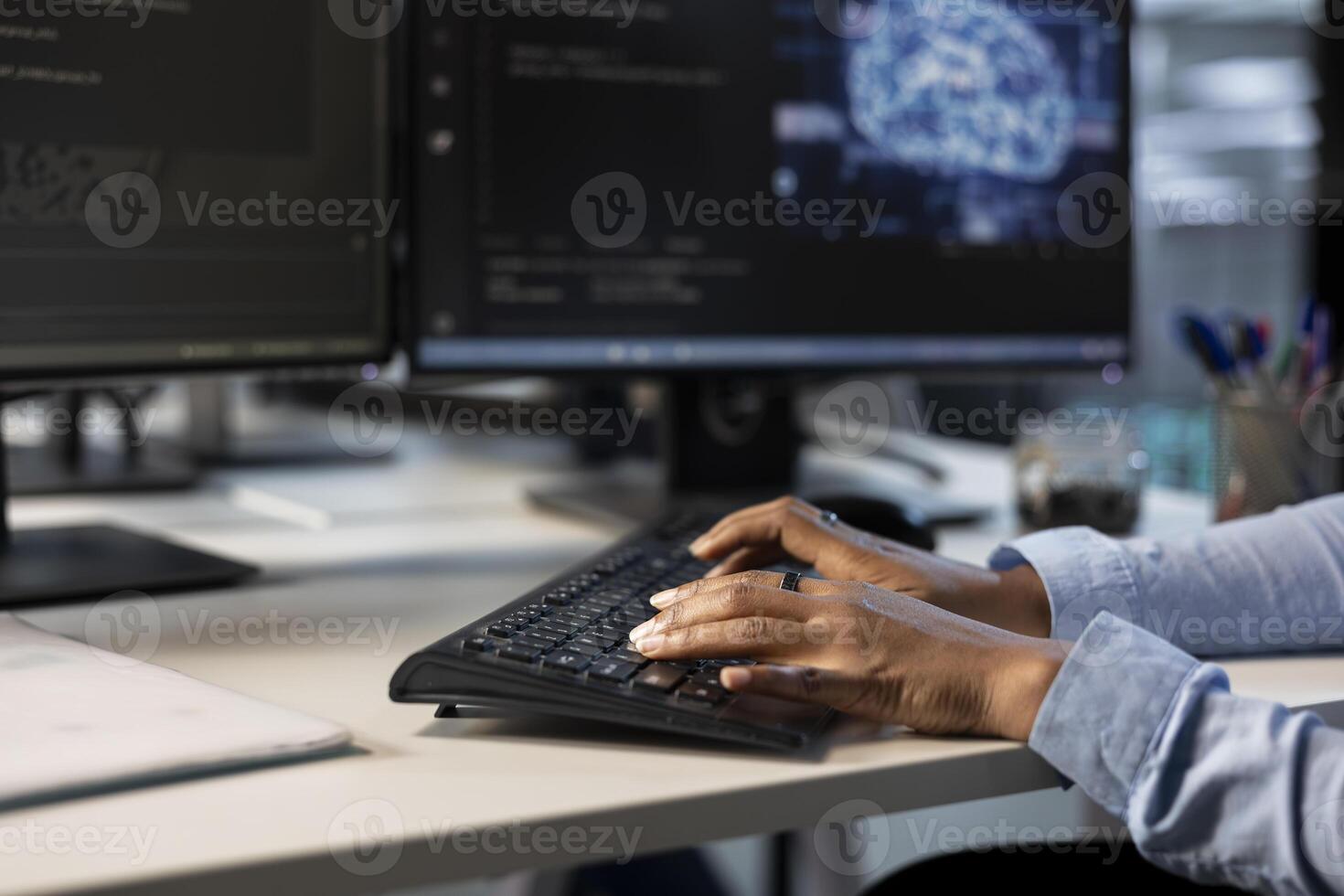 Engineer typing on keyboard in server hub, monitoring data center energy consumption using AI software. Close up of technician inspecting rackmounts in server room using artificial intelligence tech photo