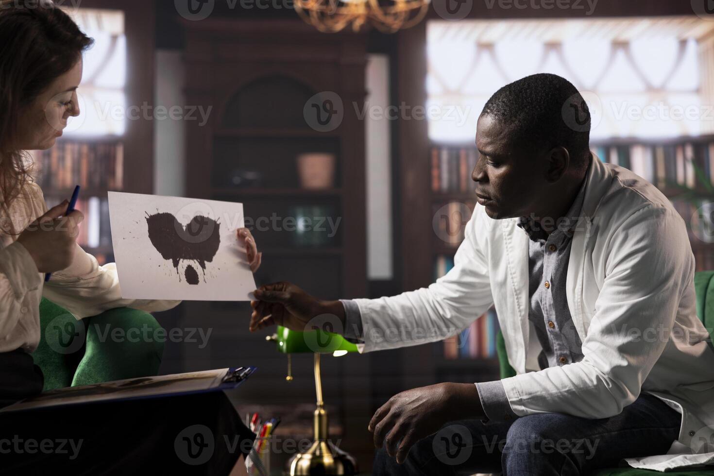 Specialist presents a Rorschach test to a doctor in white coat, looking for answers with psychoanalysis illustration. Medic surgeon suffering from PTSD and trauma, psychotherapy. photo