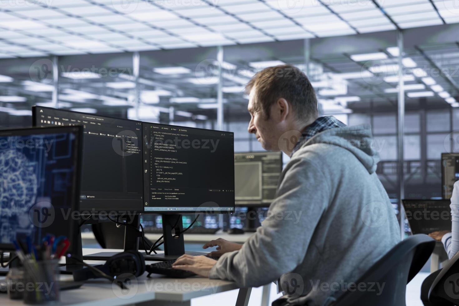 Technician using artificial intelligence technology to optimize data center workplace. Machine learning expert in server hub using AI tech to streamline operations and accurately forecast issues photo