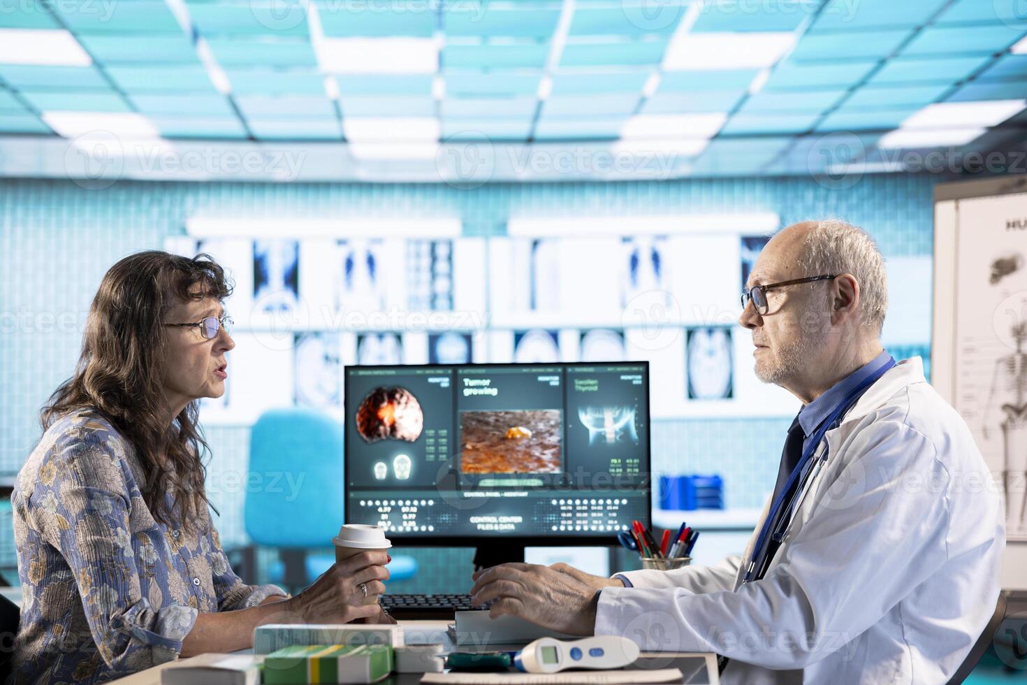 Senior doctor and patient discussing diagnostic results in a modern medical office, showcasing advanced technology using a computer displaying x rays and MRI scans. Care management. photo