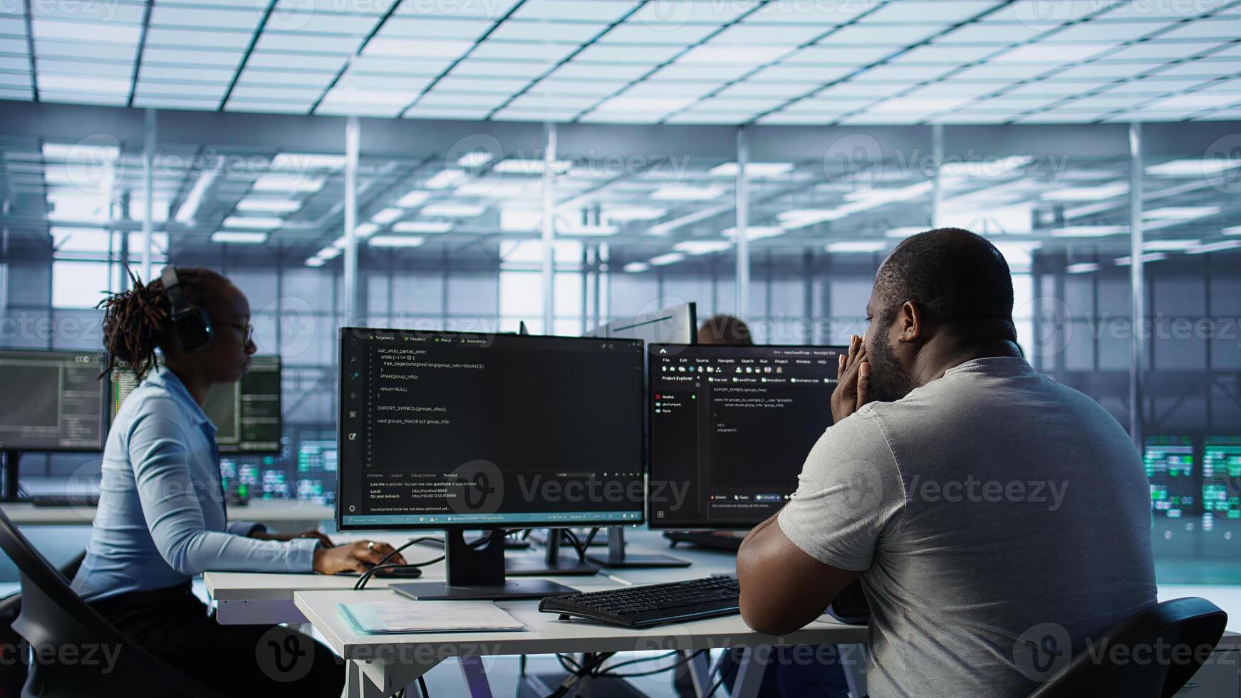 Sick IT professional in server hub sneezing while shielding data from potential threats using PC. Ill employee suffering from flu safeguarding data center against unauthorized access, camera B photo