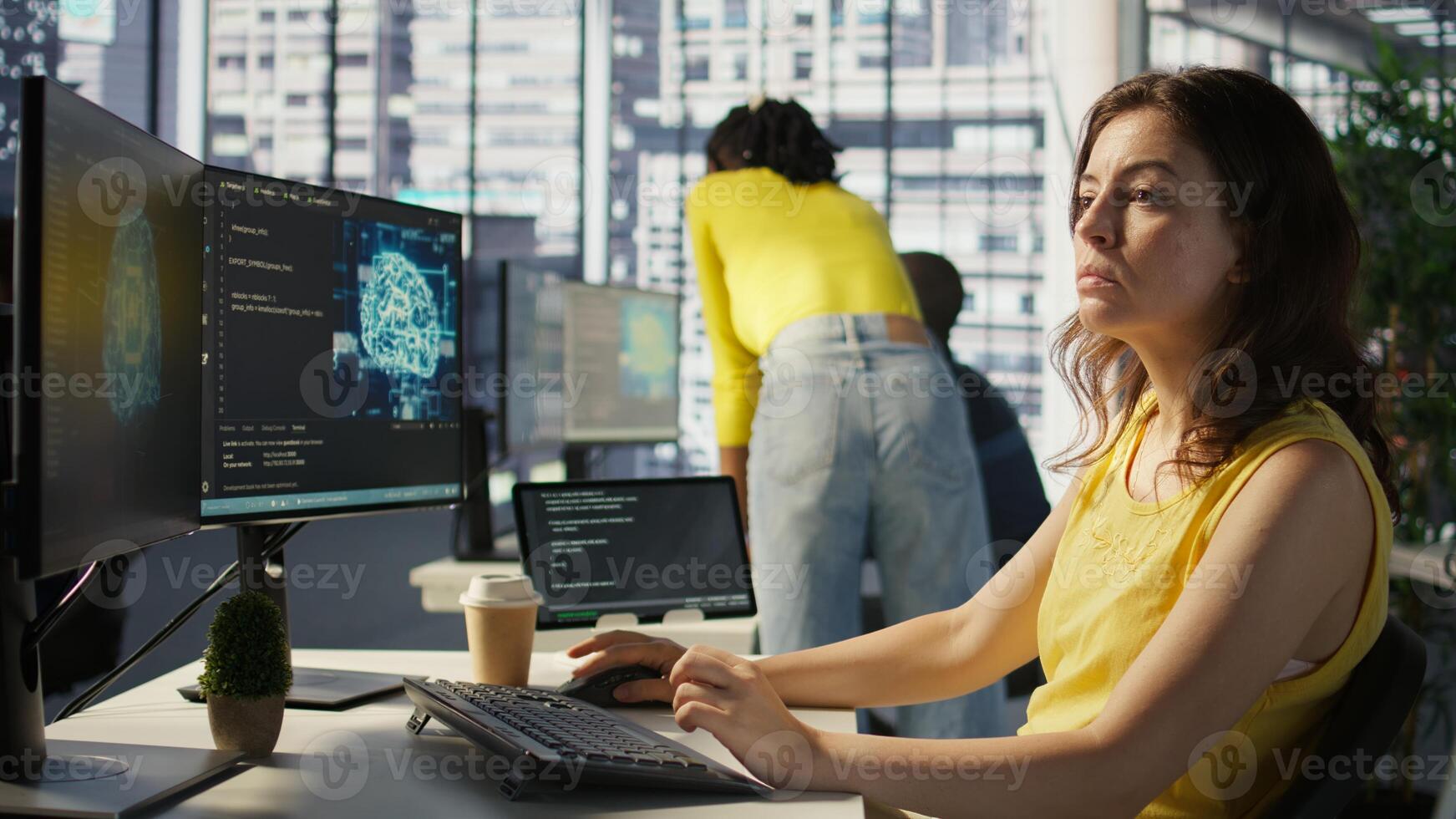Admin tests on computer and tablet to optimize artificial intelligence machine learning models for performance and accuracy. IT worker in office analyzing and interpreting complex AI data, camera B photo