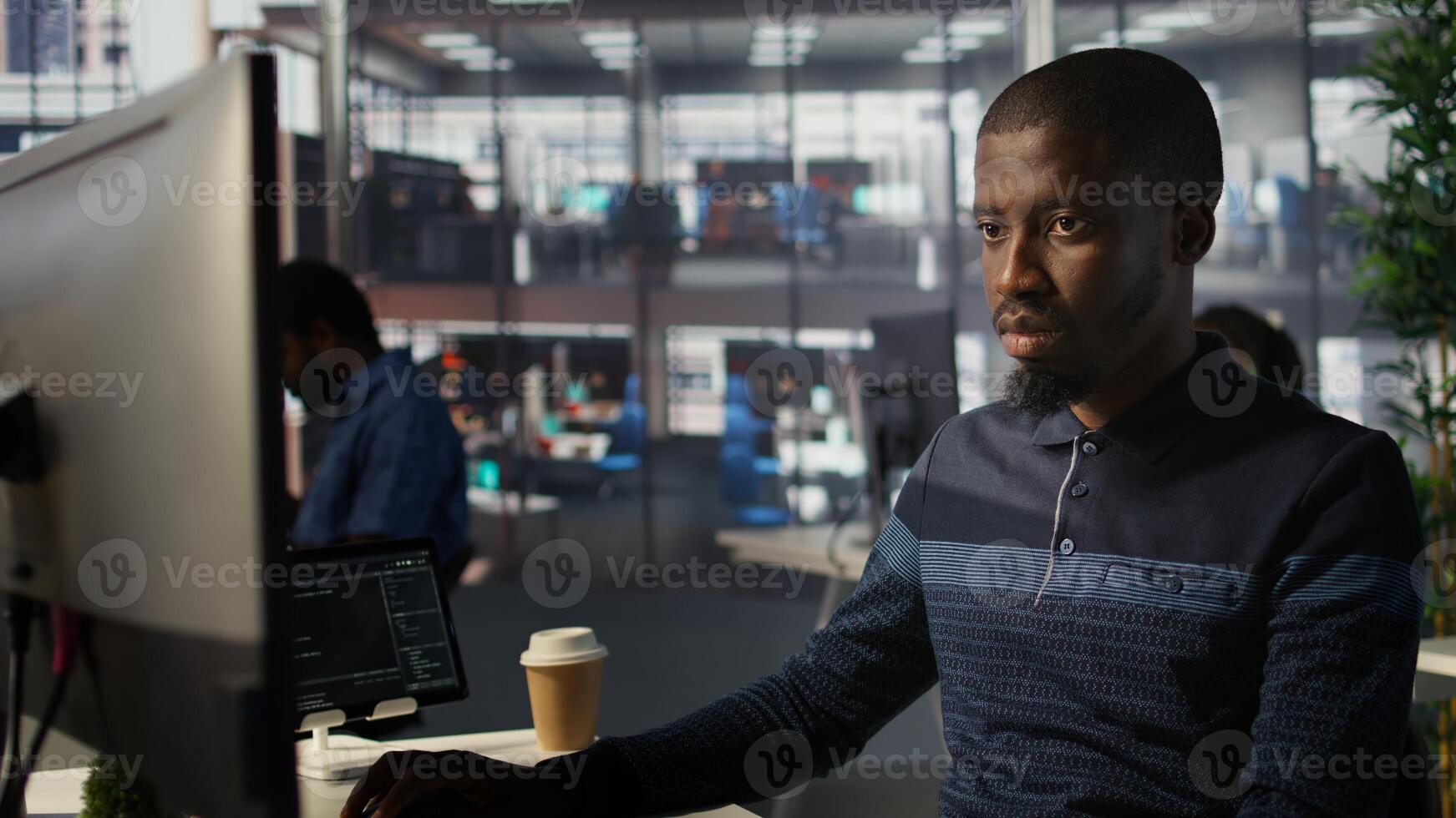 Upbeat software engineer utilizing cloud computing resources to train and deploy large scale machine learning models. Jolly man monitoring company systems, ensuring their reliability, camera B photo