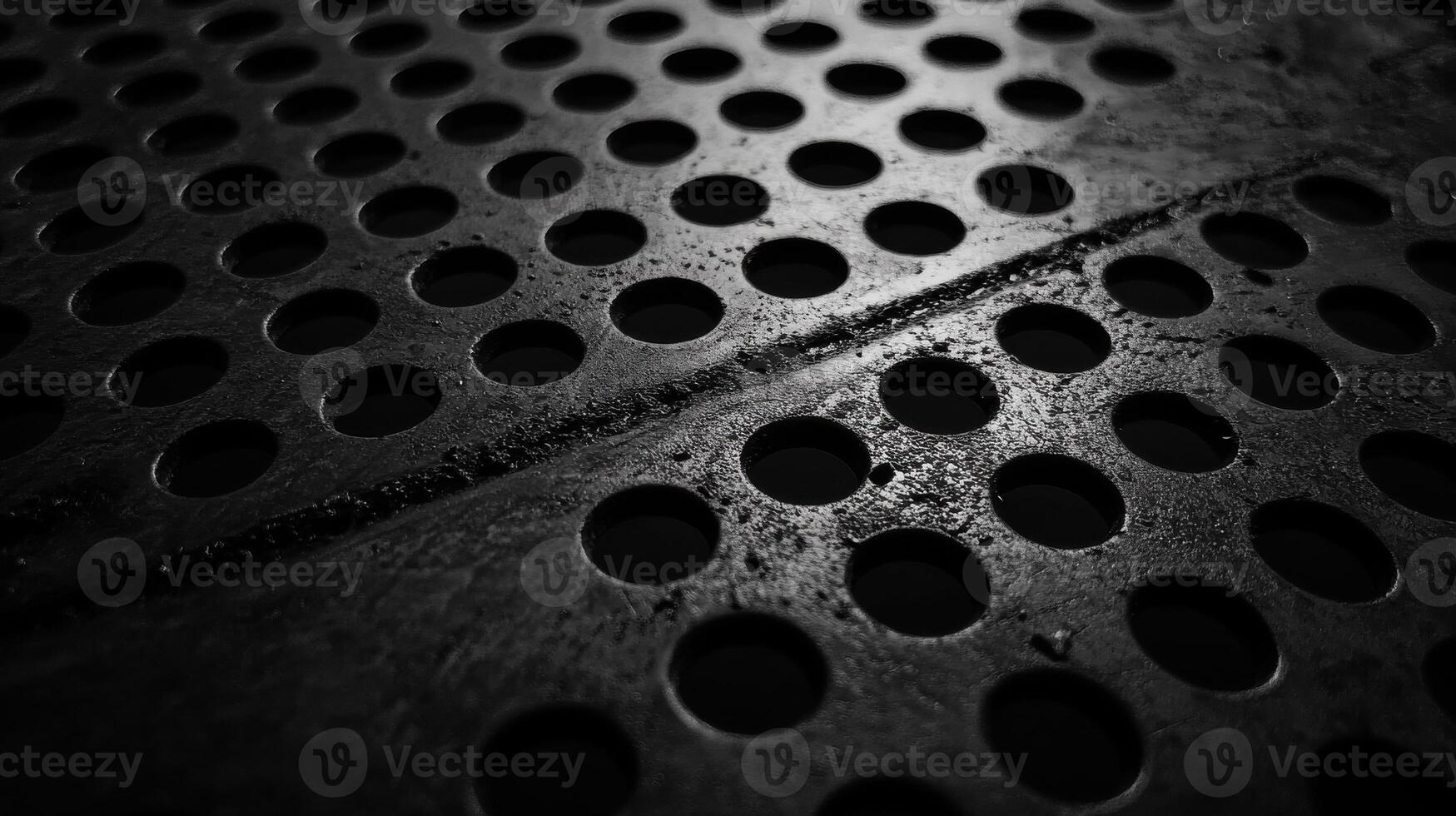 Close-up of industrial metal with circular perforations for abstract background photo