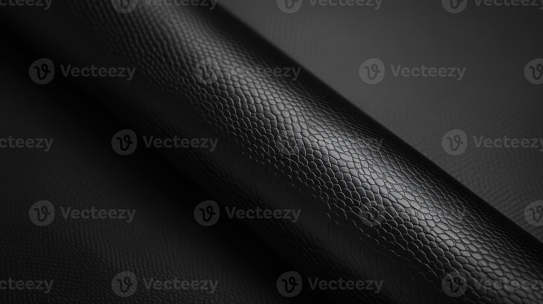 Textured black leather roll with reptile pattern for luxurious accessories design photo