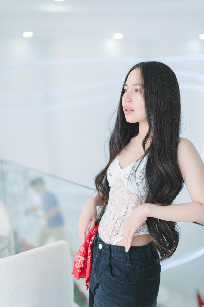 Young Woman Posing with Long Hair in Bright Modern Interior photo