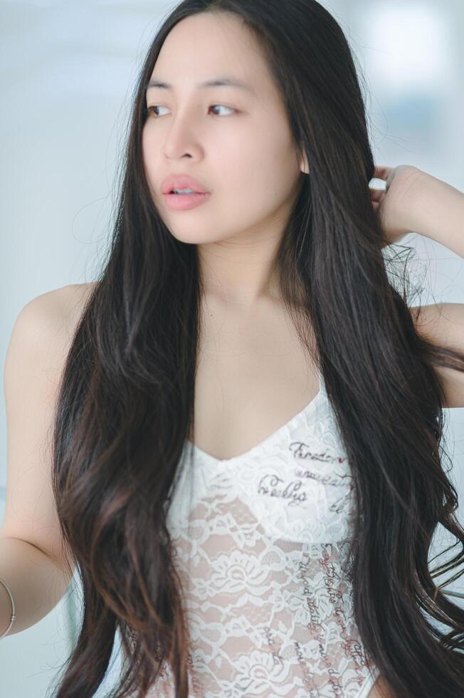 A woman in a white lace top and underwear photo