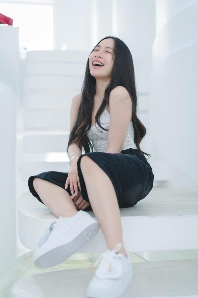 A woman sitting on a stairway laughing photo