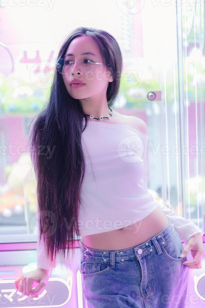 Stylish Woman Posing with Long Hair in Neon Urban Environment photo