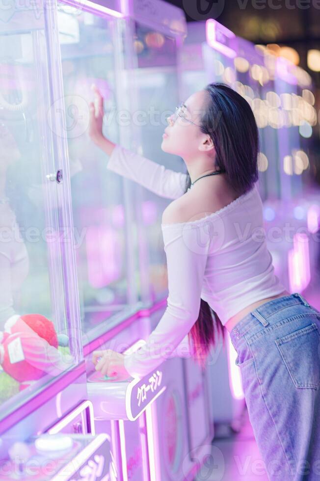 Young Woman Enjoying Neon Arcade Games in Vibrant Indoor Space photo