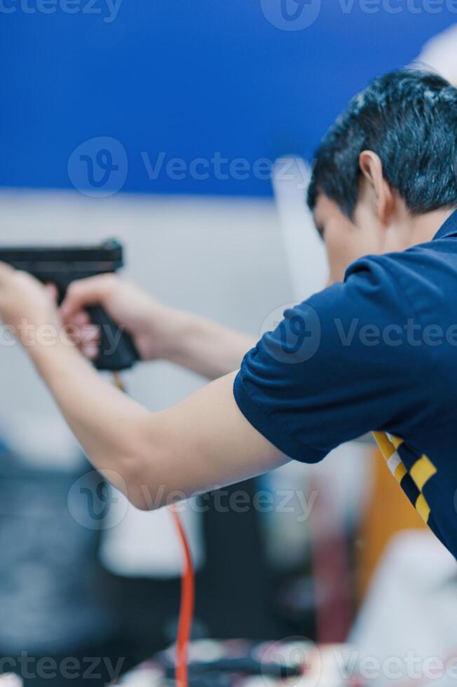 Individual Aiming Firearm in Indoor Shooting Range with Focus photo