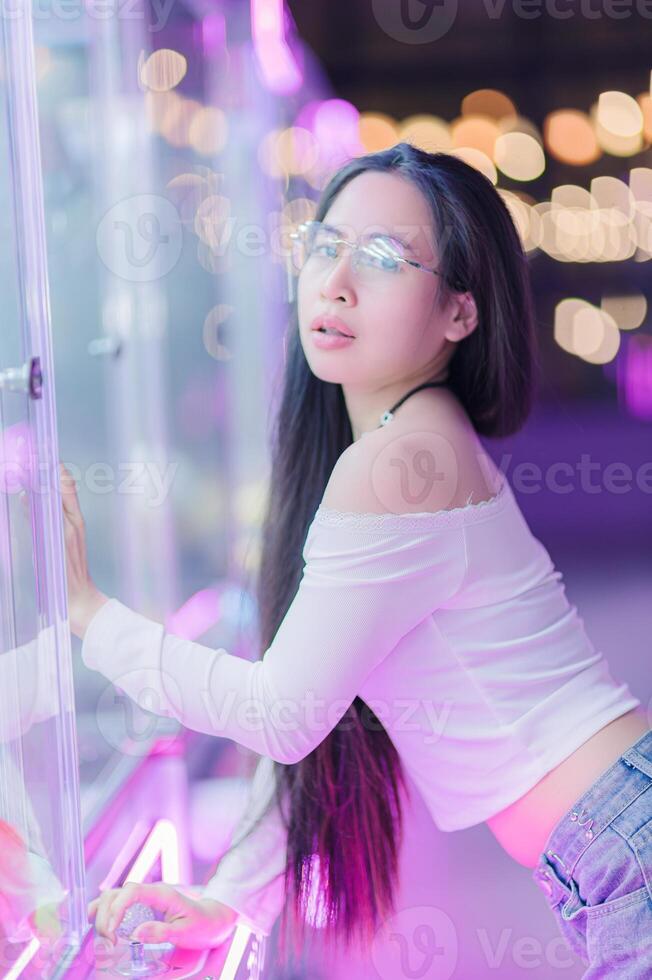 Stunning Woman in White Top Posing with Neon Lights Background photo