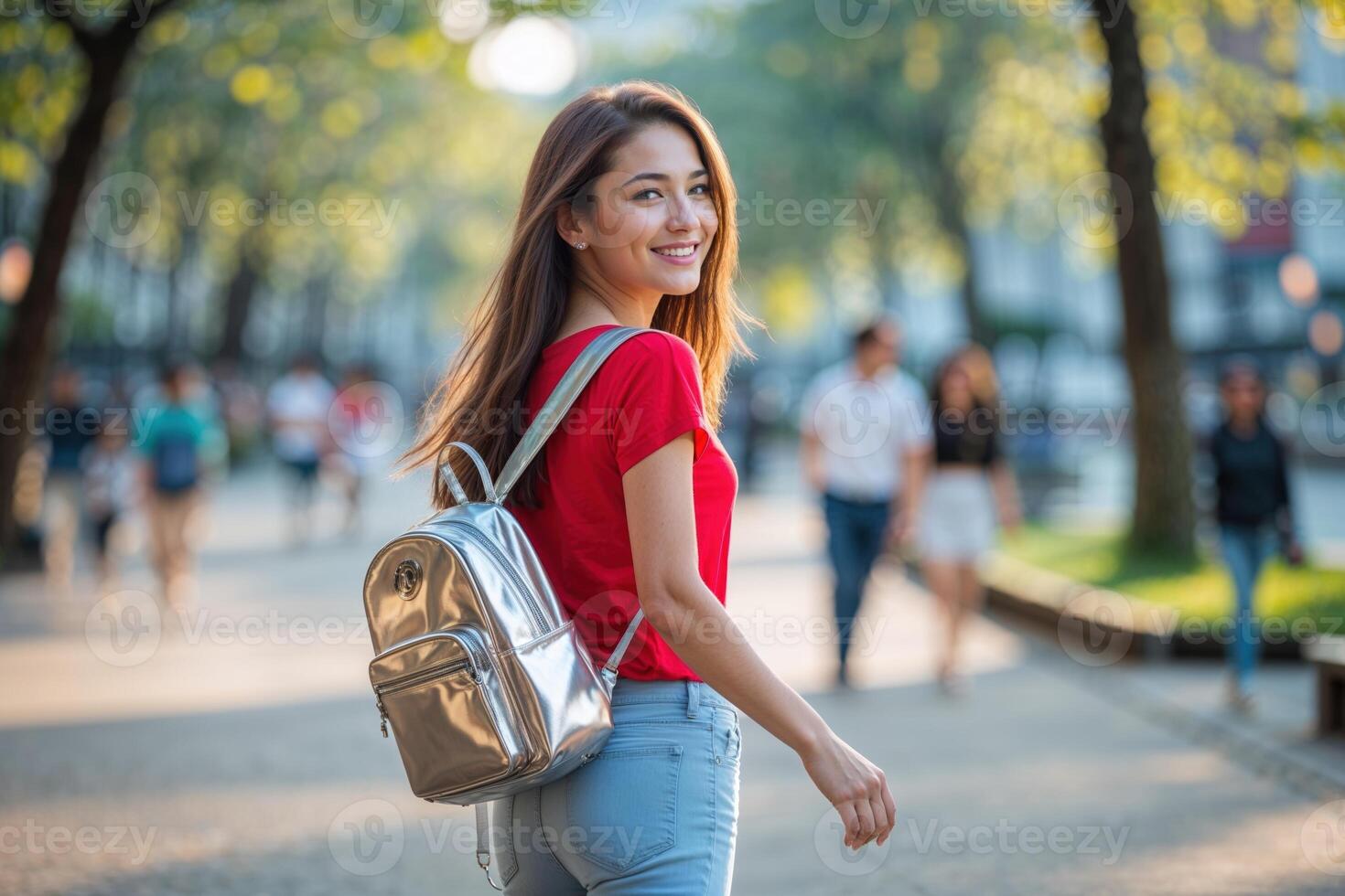Young Woman with Silver Backpack Walking on City Street photo