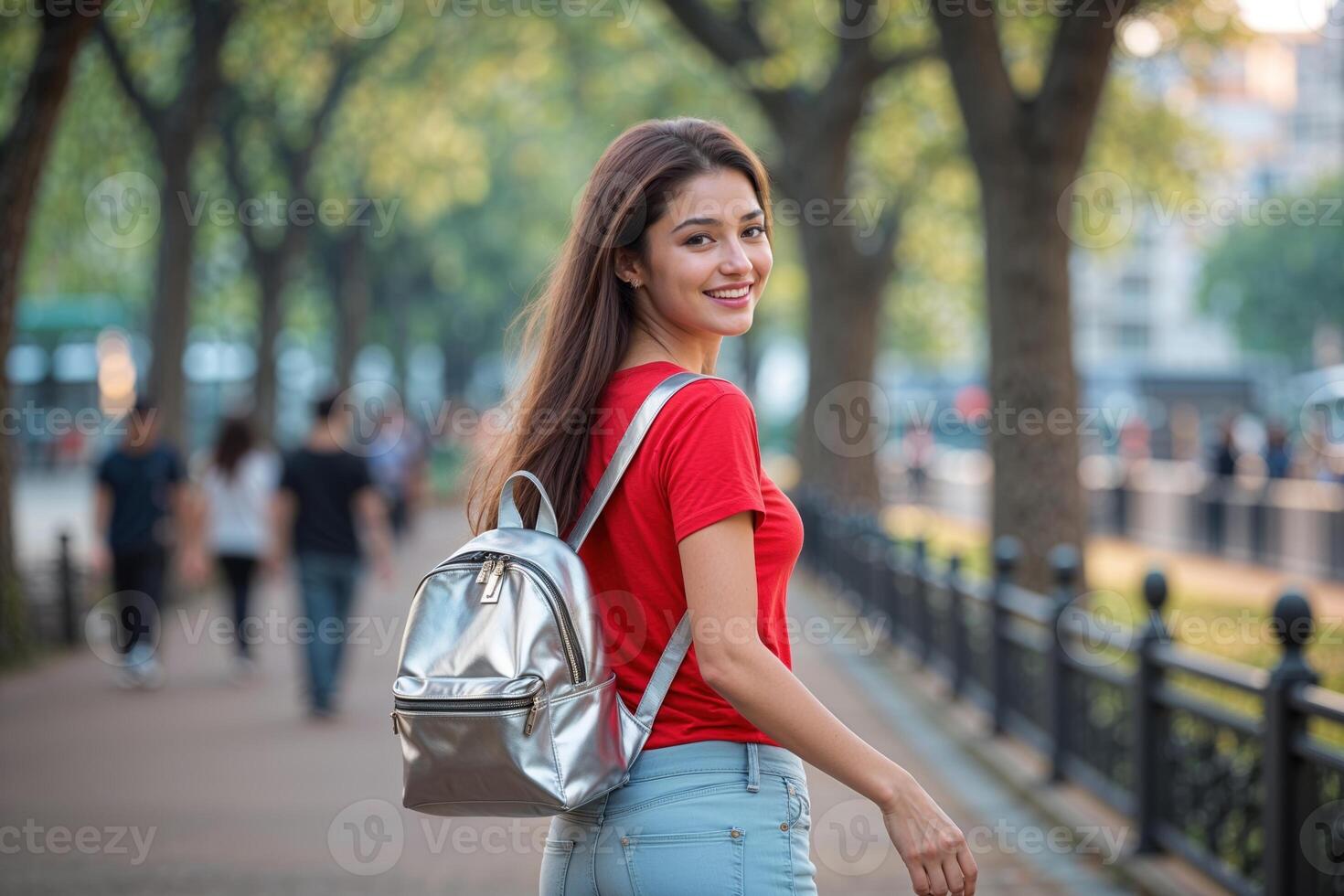Young Woman with Silver Backpack Walking on a Path photo