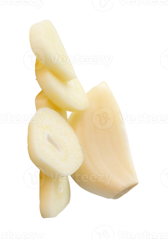 A peeled white garlic clove with slices in pile isolated with clipping path in file format png