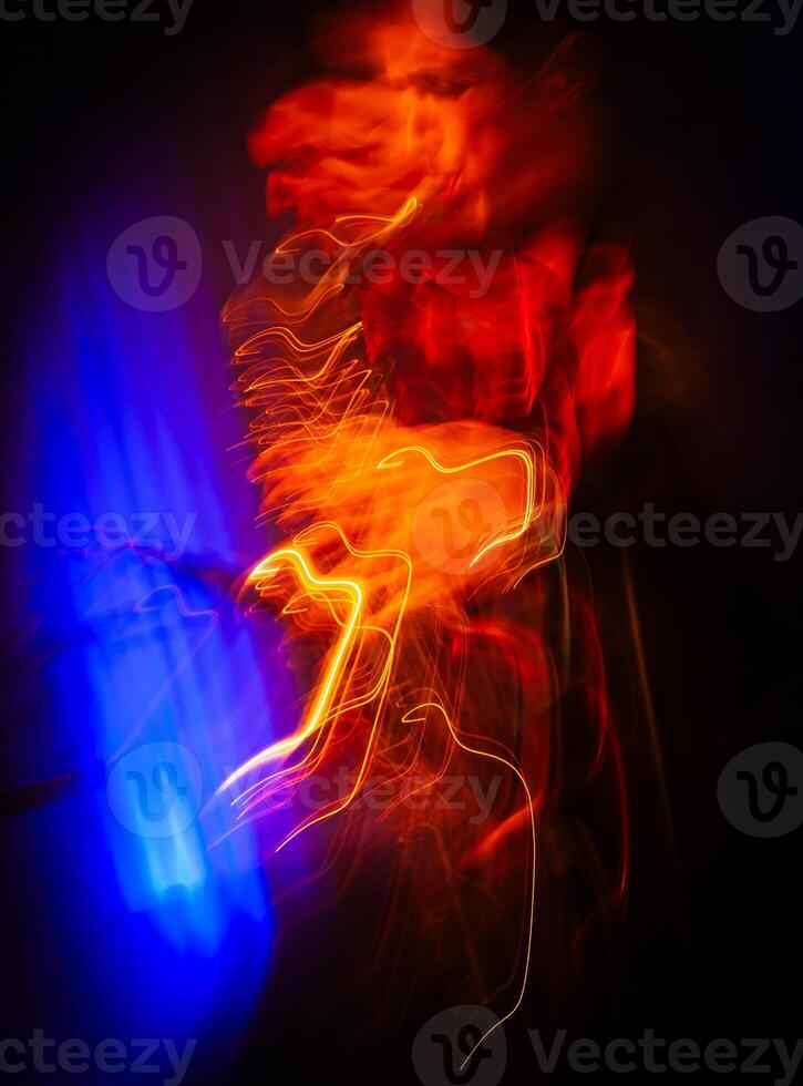 Saxophone Player on Stage. Fiery Light Trails Dance photo