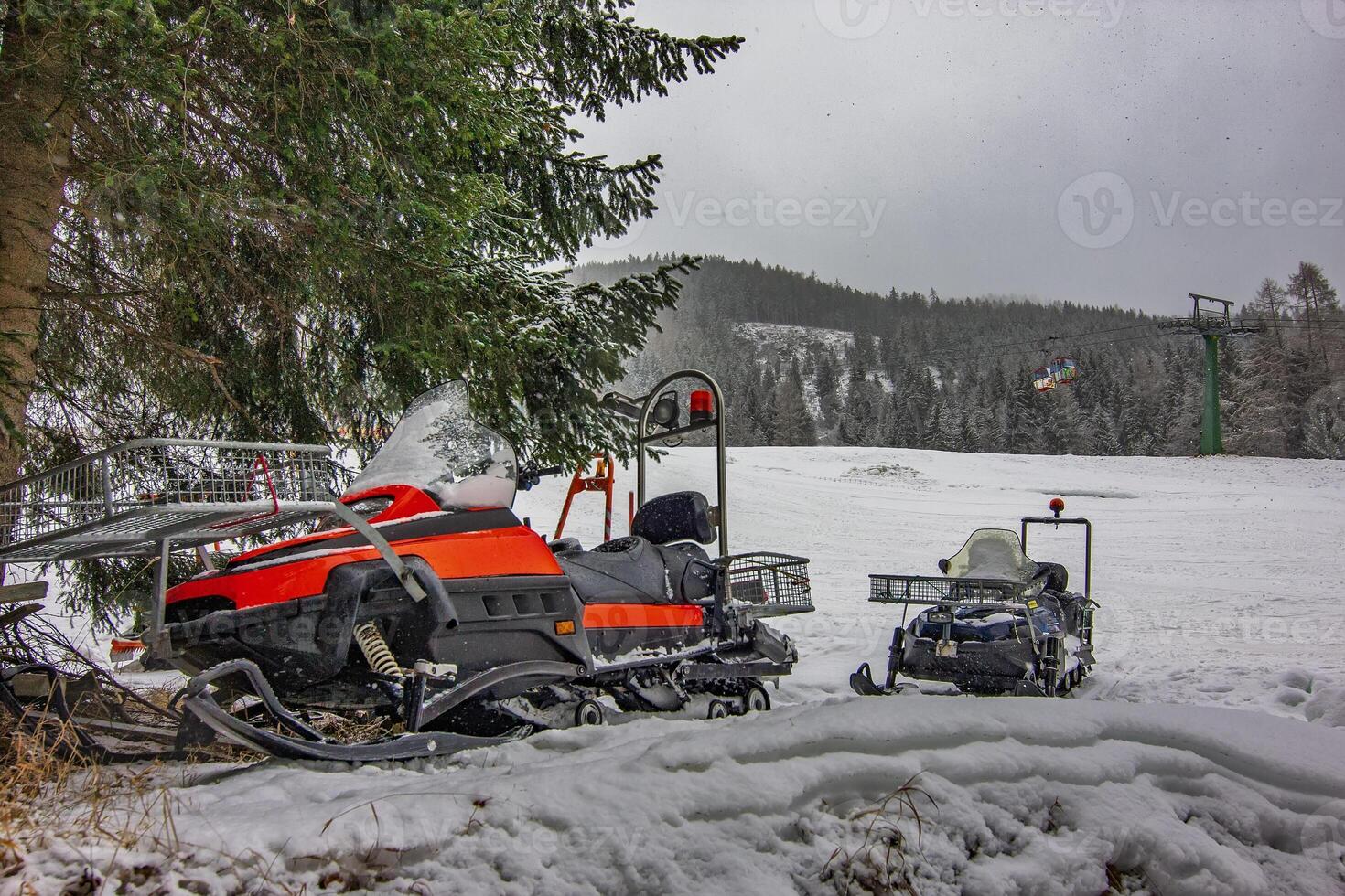 Snowmobile parked in winter park photo