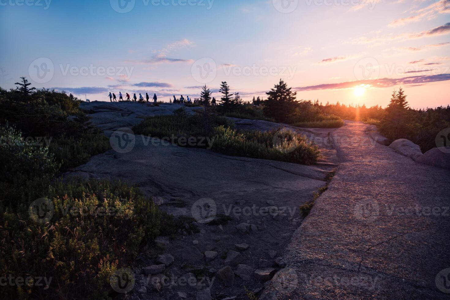 people on the highest point of Acadia National Park in Maine during a sunset photo
