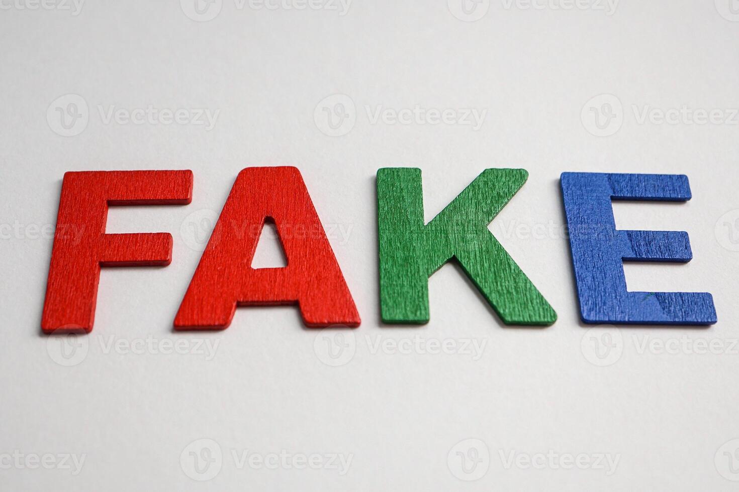 word fake with colorful letters on white background photo