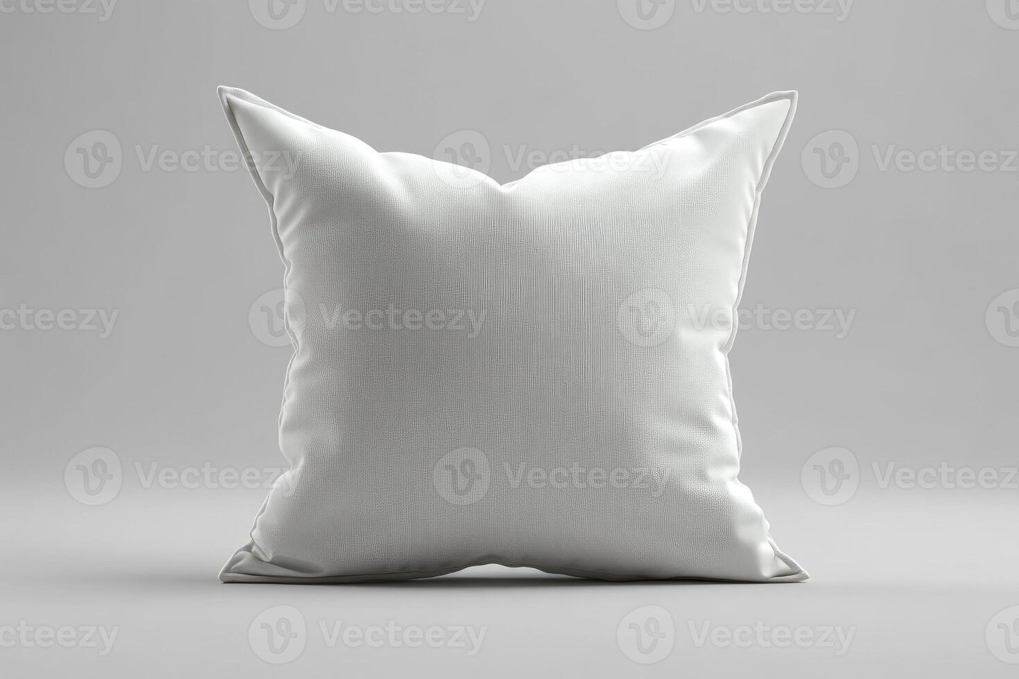 Single white square pillow resting on gray background. photo