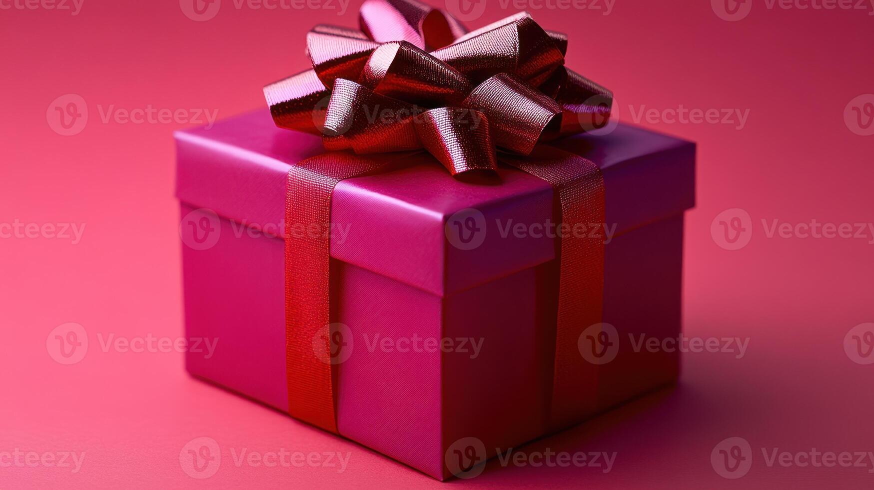 This delightful gift box showcases a vibrant pink color with a glossy ribbon and bow photo