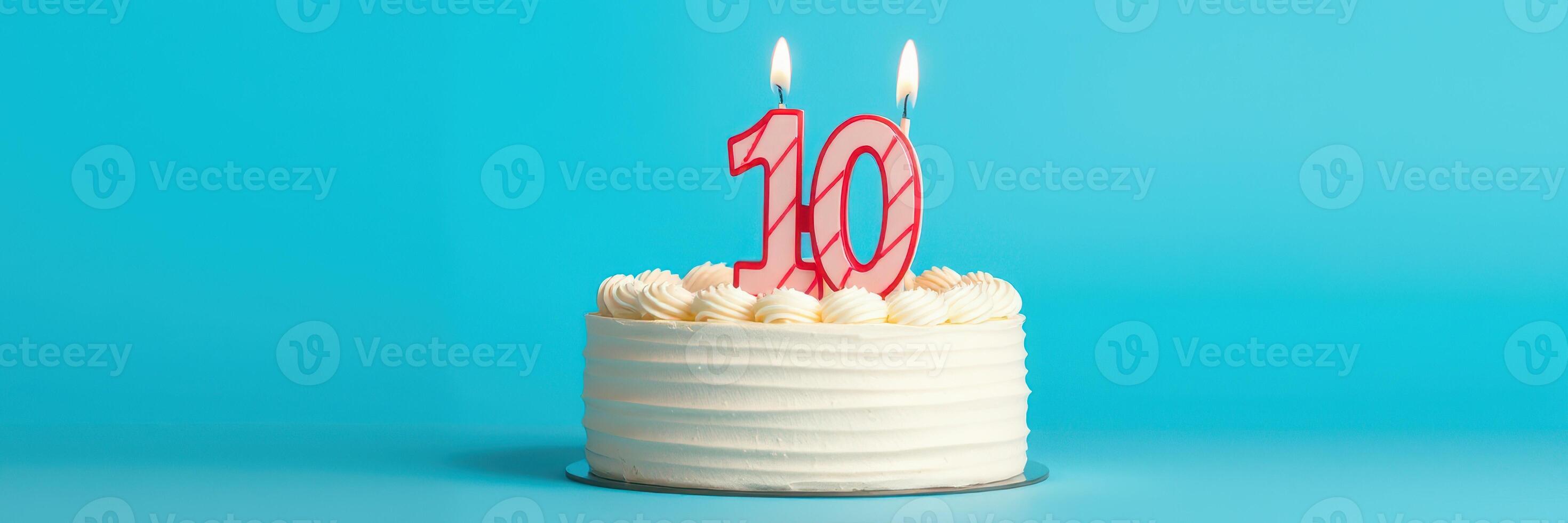 Celebrating a milestone with a beautifully decorated cake featuring a red ten candle against a vibrant blue background photo