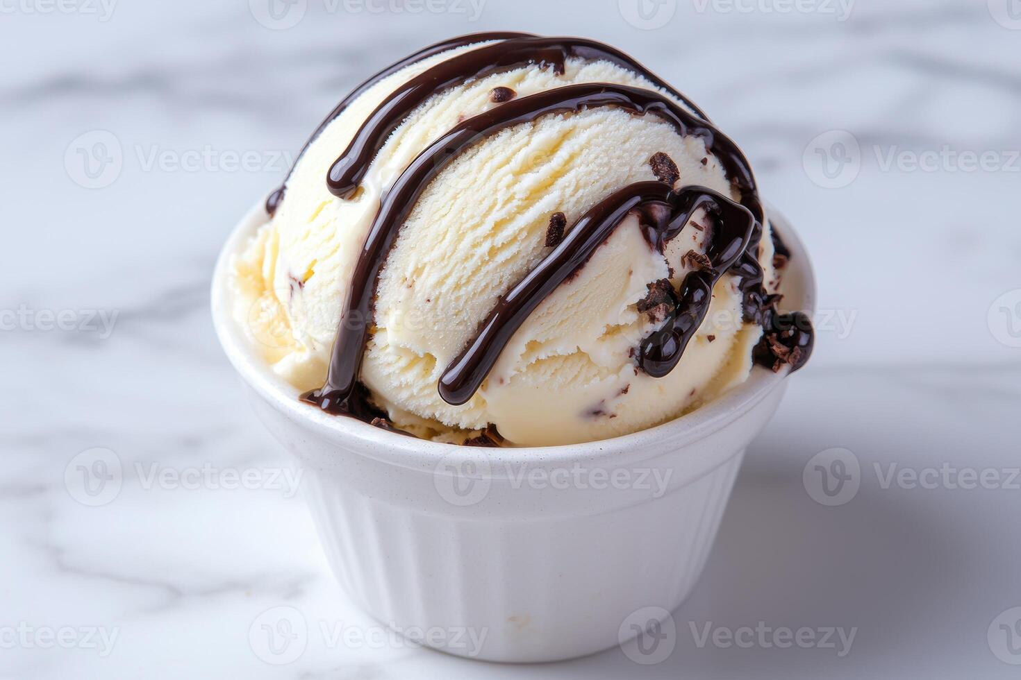 Close up of a scoop of vanilla ice cream with chocolate sauce photo
