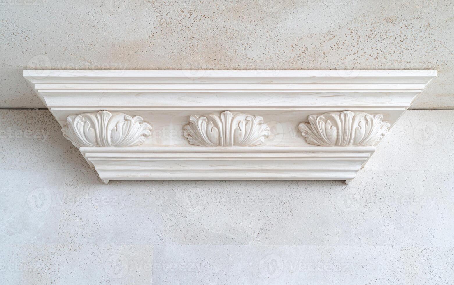 A white ornate crown molding detail on ceiling photo
