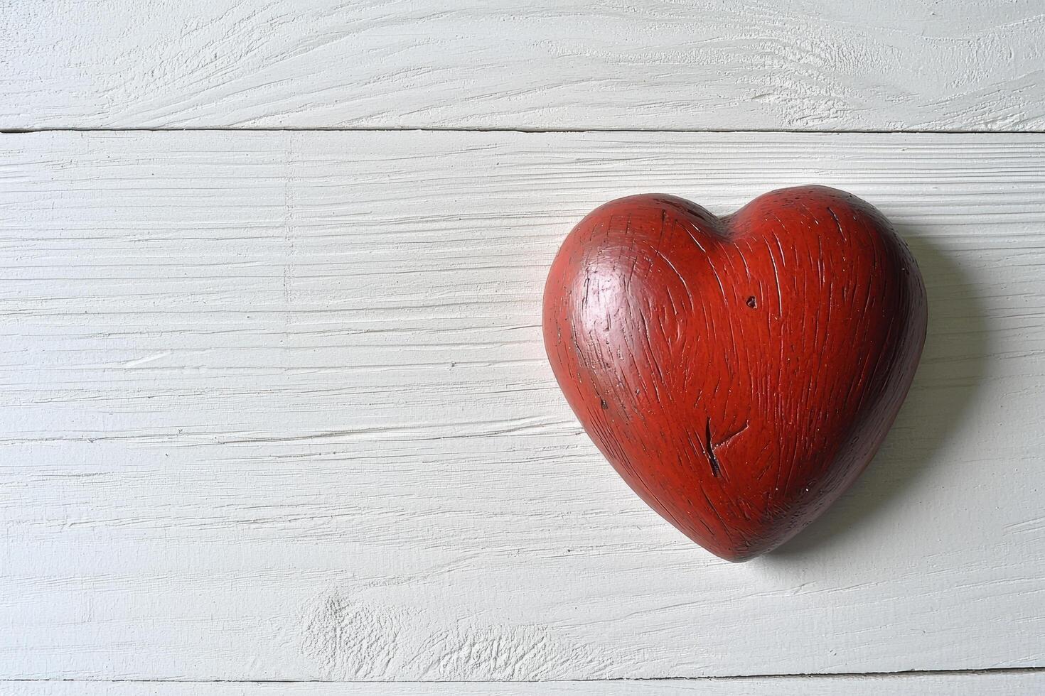 Red heart on white wooden background photo
