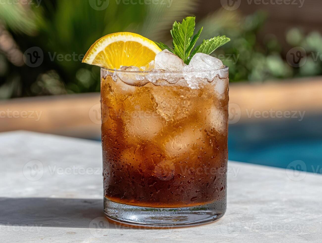 Refreshing iced tea with lemon and mint by the pool photo