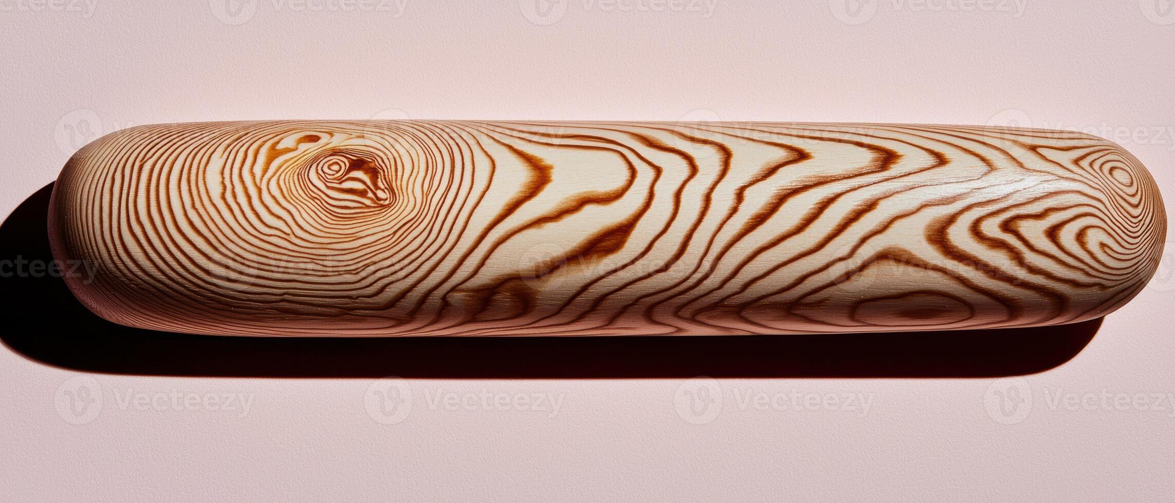 Close up of a wooden rolling pin with unique grain pattern photo