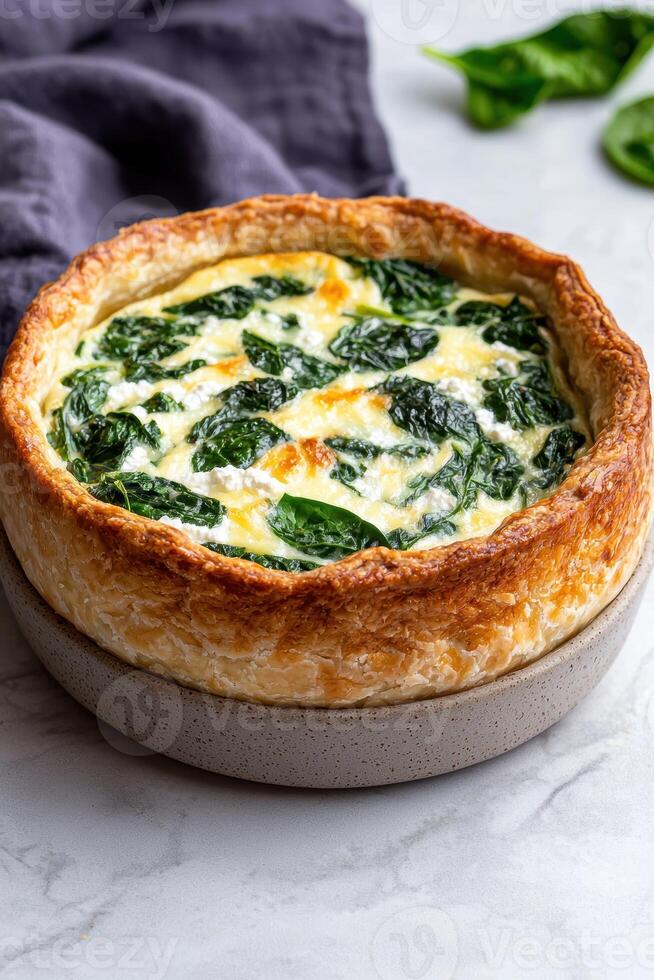 Delicious spinach and feta quiche in a flaky puff pastry crust photo