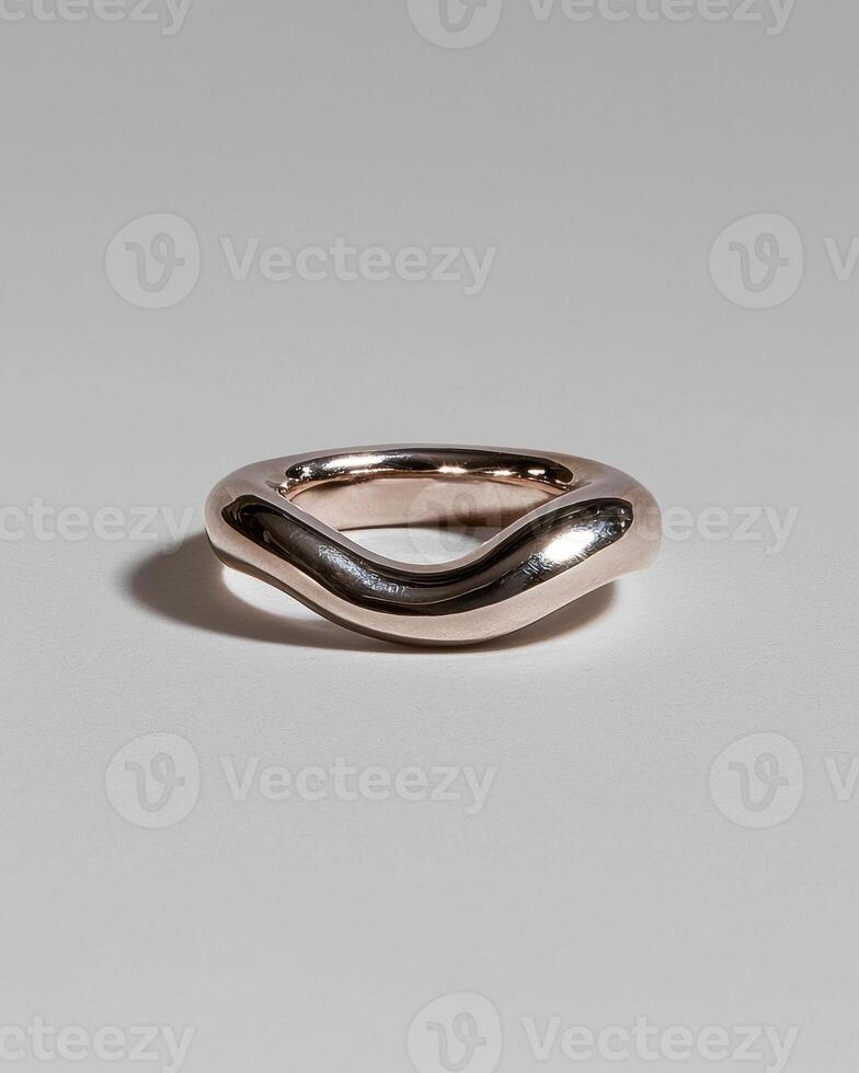 Rose gold wavy ring on white background photo