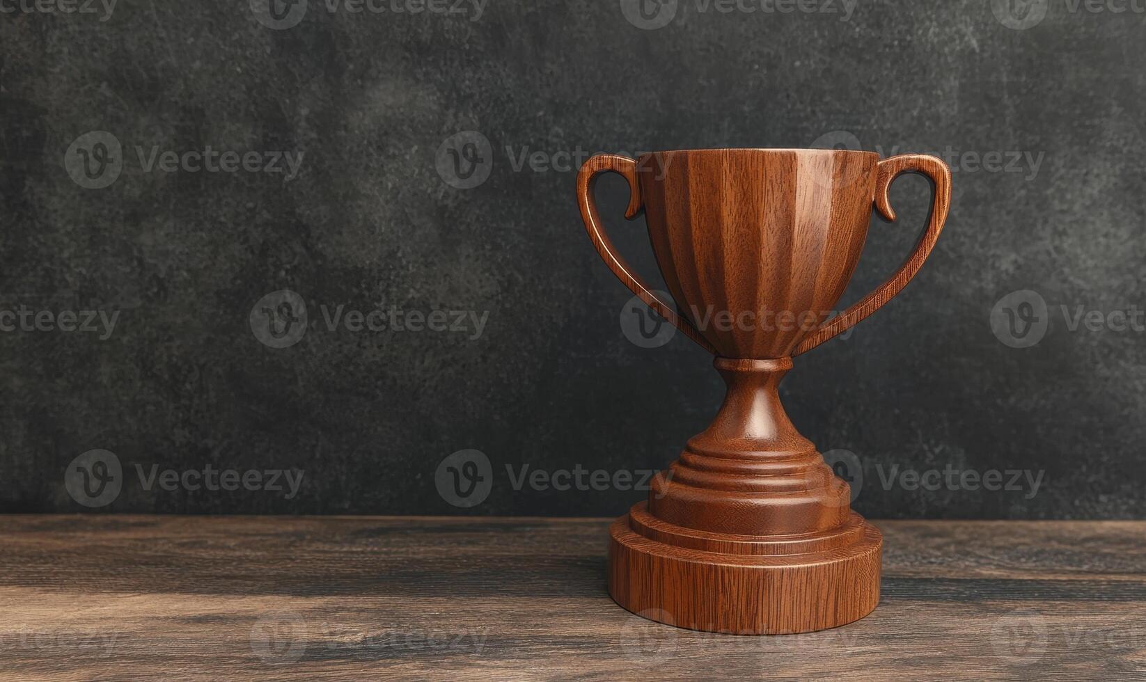 Wooden trophy on a dark wooden table against a dark background photo