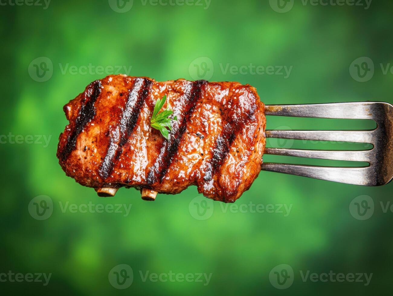 Grilled meat on a fork with green background showcasing delicious barbecue cooking techniques photo