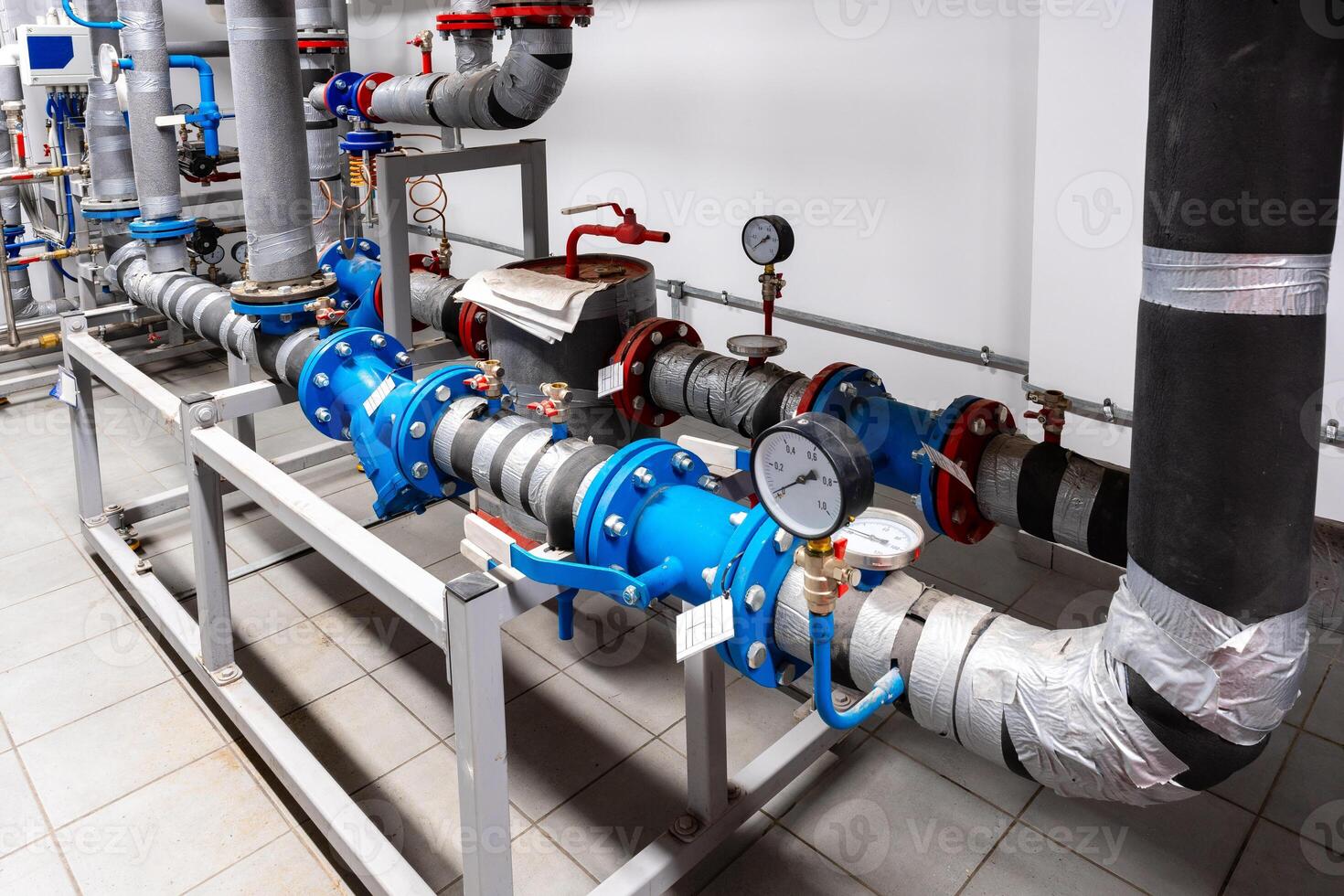 Industrial piping system showing blue and gray pipes and measuring instruments in a modern facility photo