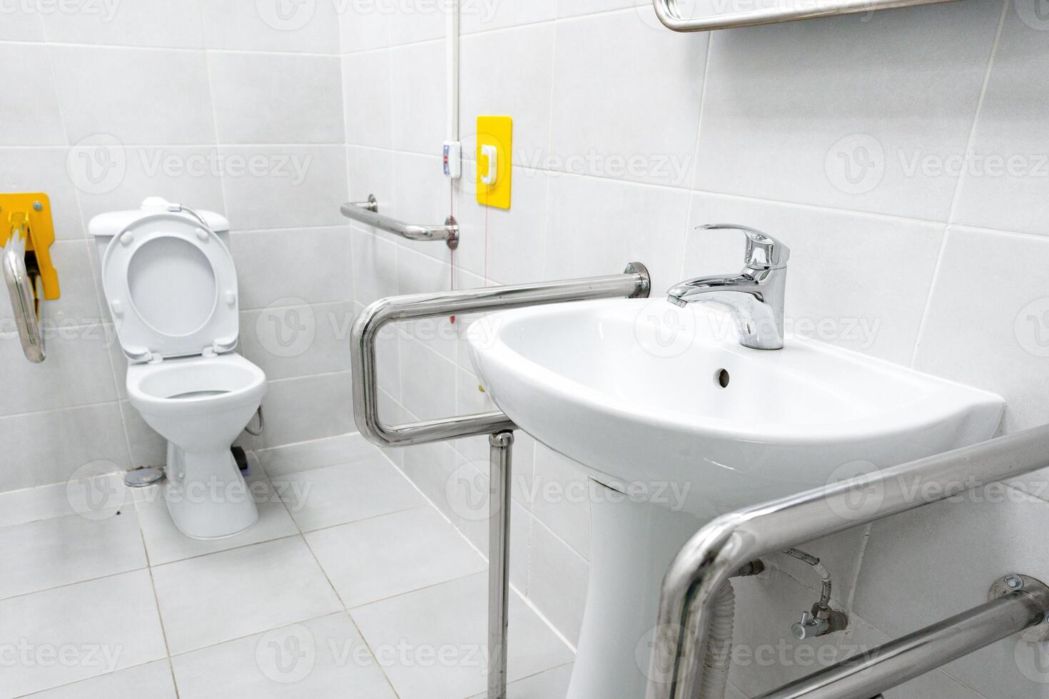 Accessible restroom featuring grab bars and modern fixtures for inclusive use photo