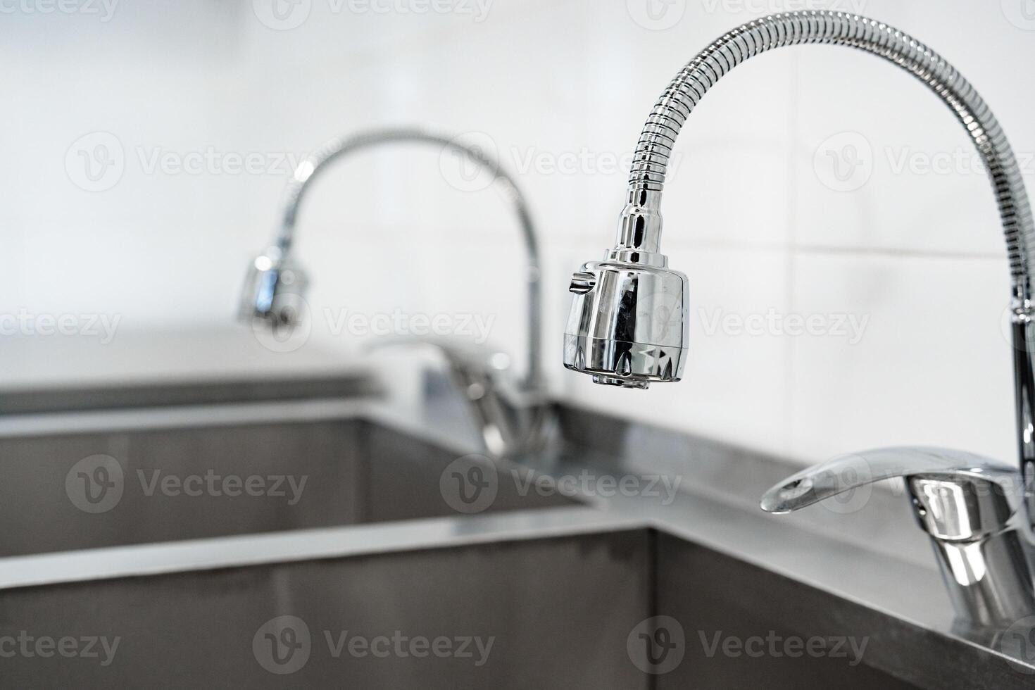 Modern kitchen sinks and faucets showcase sleek design and functionality in a contemporary environment with a minimalistic style photo