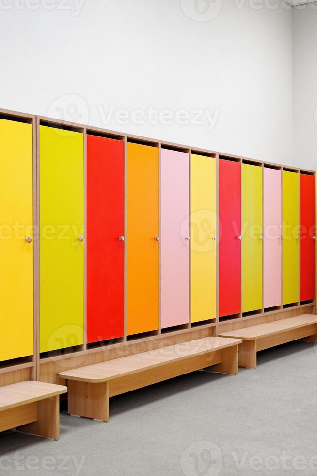 Brightly colored locker doors line a minimalist space designed for organized storage and personal belongings at a recreational facility photo
