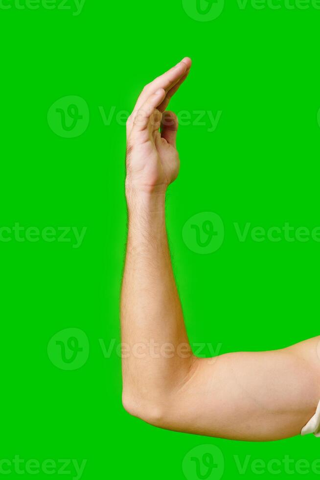 Hand Gesture Above Arm Against Bright Green Background photo