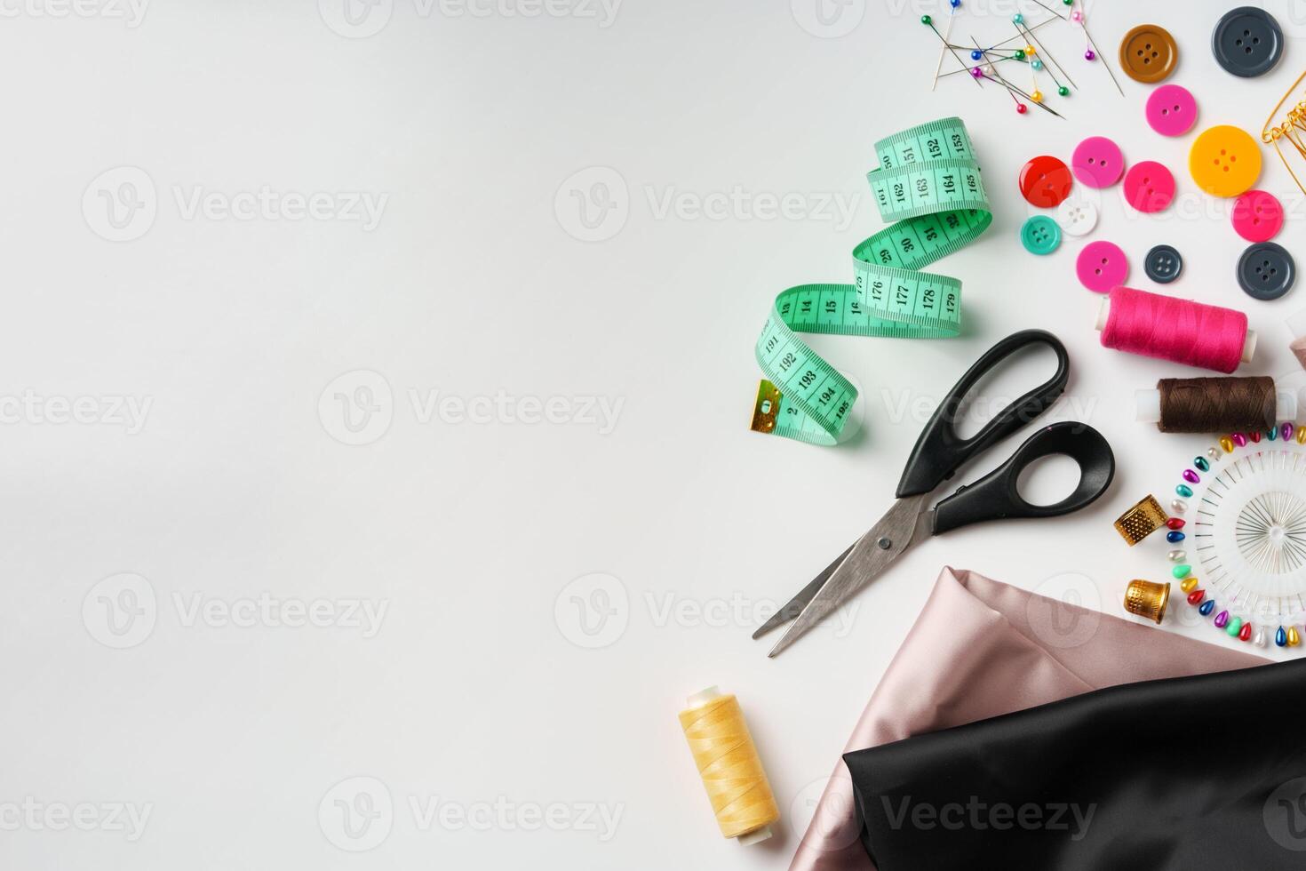 Crafting essentials for sewing projects displayed on a table with fabric, threads, and tools photo