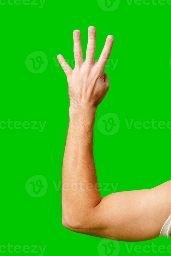 Person Holding Up Four Fingers Against Bright Green Background photo