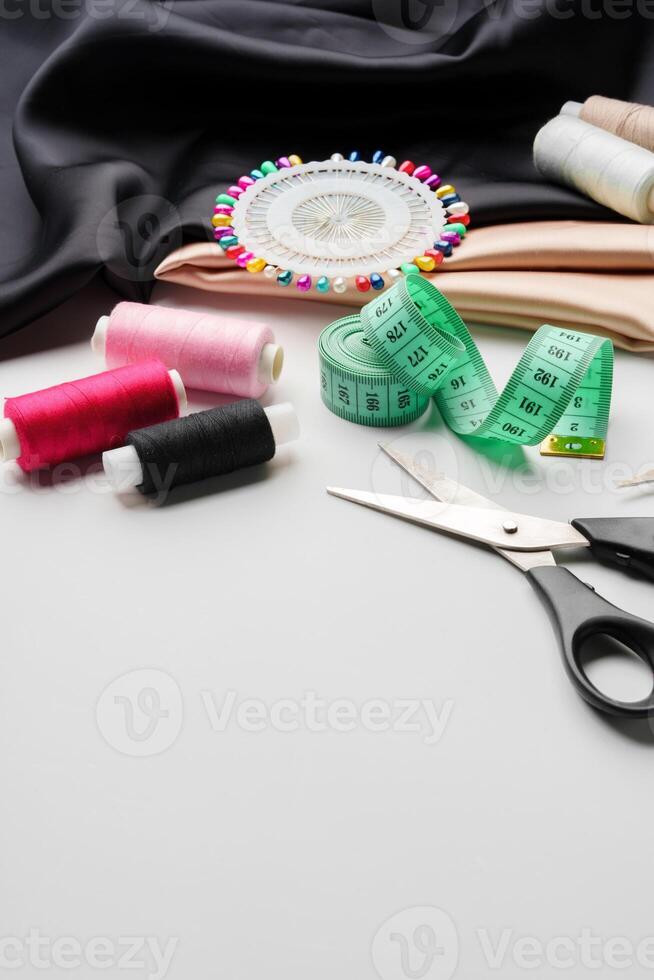 Crafting essentials for sewing projects displayed on a table with fabric, threads, and tools photo