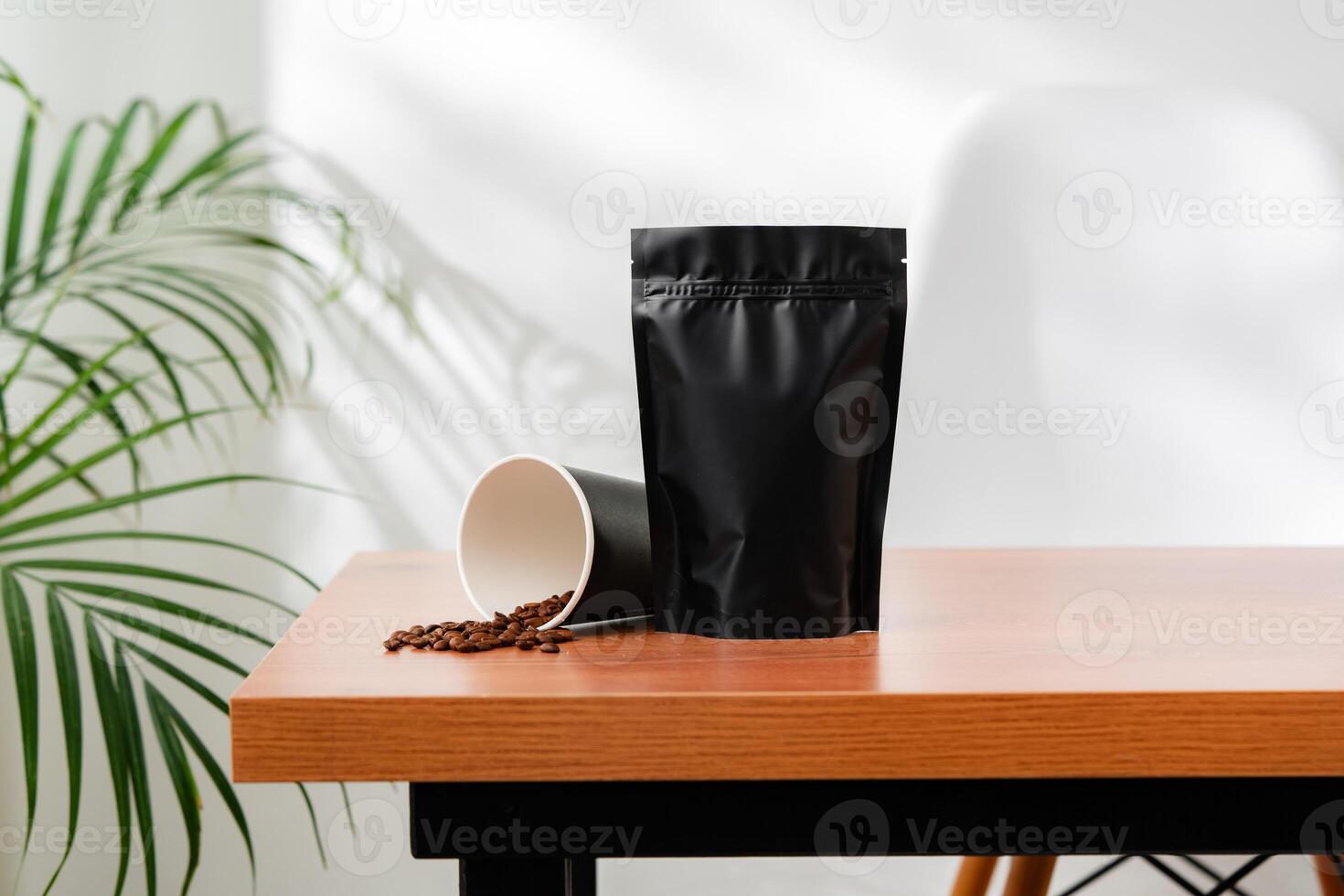 Three beverage containers and a paper bag on a wooden table photo