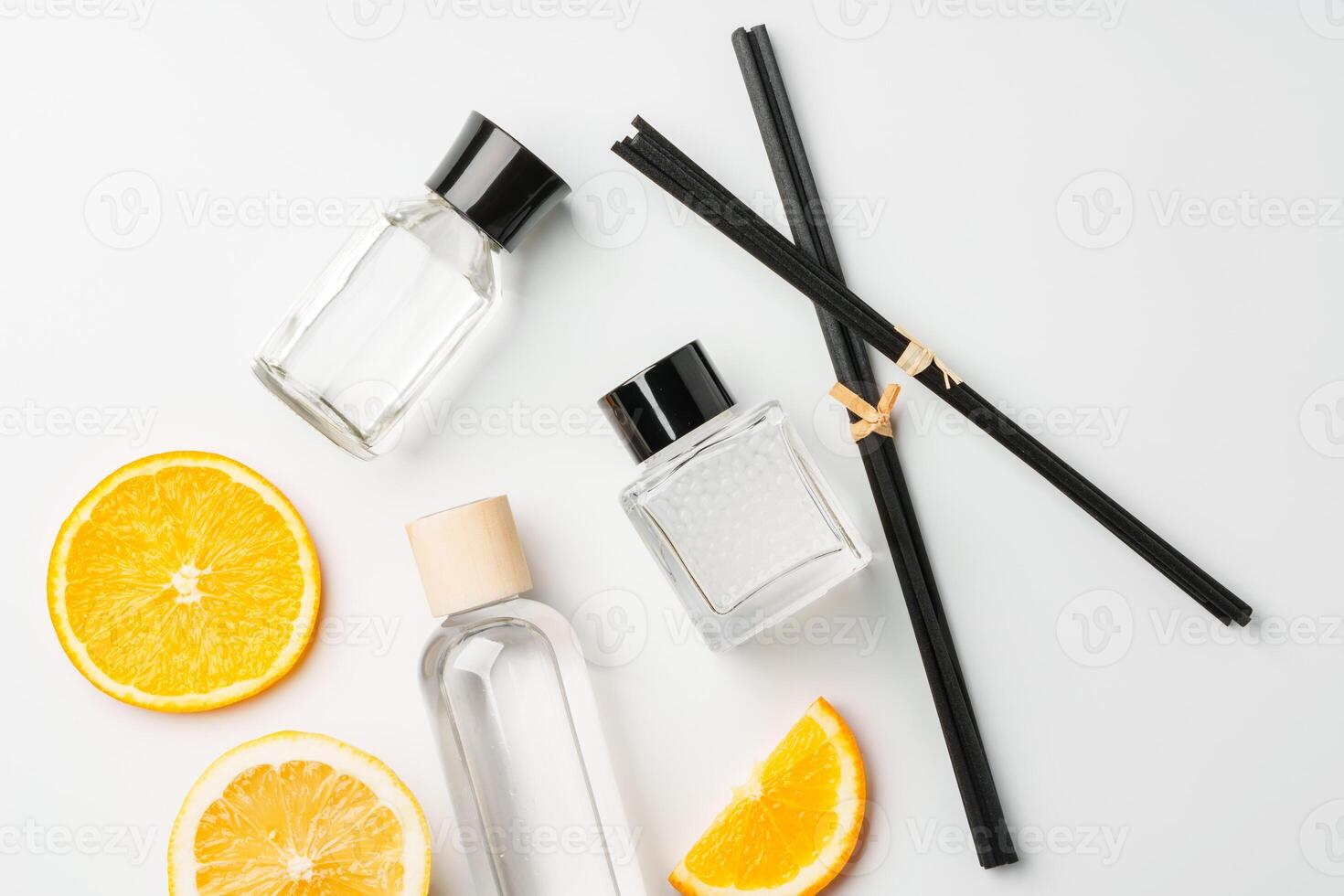 Aromatic display of essential oils with citrus fruit and chopsticks on a minimalist background photo