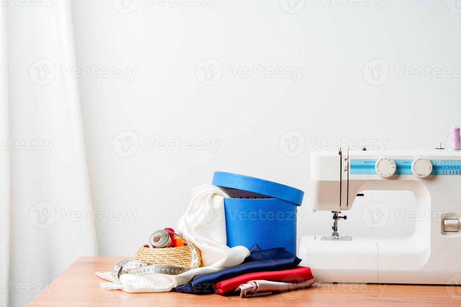 A sewing machine with colorful threads and fabric in a bright crafting space for creative projects photo