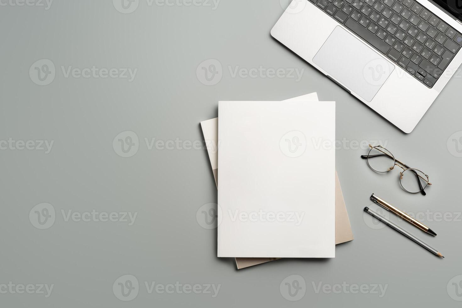 Organized Workspace Featuring Laptop and Blank Paper at Desk in Natural Light photo