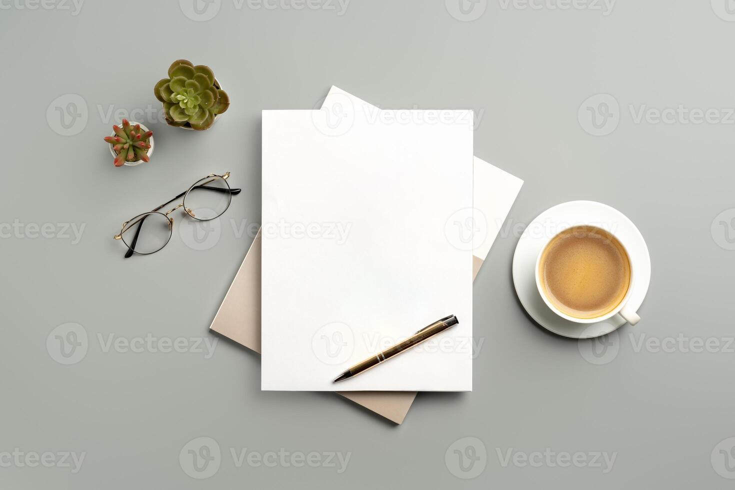 Cozy Workspace With Notepad, Pen, Glasses, and Coffee on Minimalist Desk photo